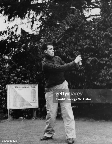 Leslie Compton , Centre half for Arsenal Football Club and right handed batsman and bowler for Middlesex County Club tees off during a golf match...