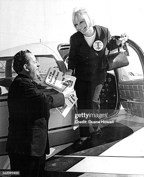 Flighty, But for a Cause; Actress Susan Oliver climbs out of her Aero Commander 200, which she is flying around the United States aiding the Easter...
