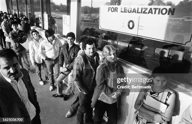 Undocumented people wait in line outside the U.S. Immigration Office for a last chance to apply for legal residency before the government's amnesty...