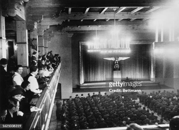 People gather in the new meeting room hall during the ceremony off its opening, Garmisch-Partenkirchen, Germany, 28th January 1935.