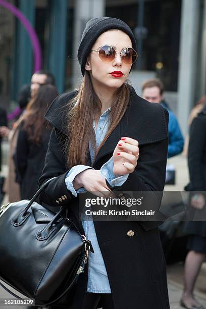 London, EnglandA model carrying a Givenchy bag on day 4 of London Womens Fashion Week Autumn/Winter 2013 on February 18, 2013 in London, England.