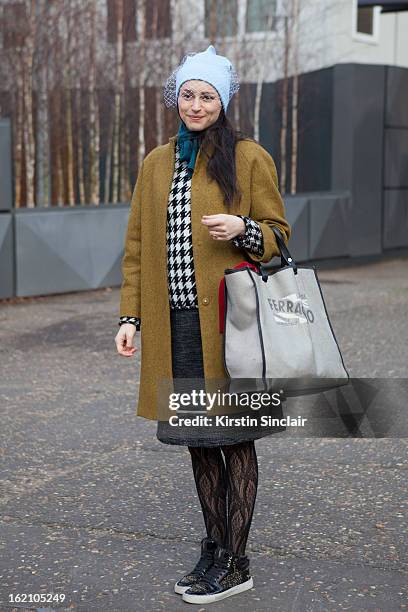 London, EnglandUrsula Geisselmnn wearing jill sander hat, cos jacket, marni skirt, Yves Saint Laurent shoes and salvatore ferragamo bag on day 4 of...