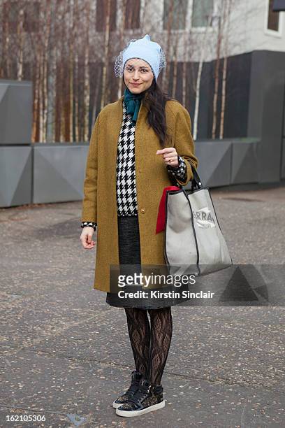 London, EnglandUrsula Geisselmnn wearing Jill Sander hat, Cos jacket, Marni skirt, Yves Saint Laurent shoes and Salvatore Ferragamo bag on day 4 of...