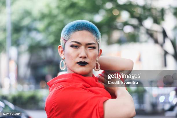 portrait of transgendered person posing - blue hair stock pictures, royalty-free photos & images