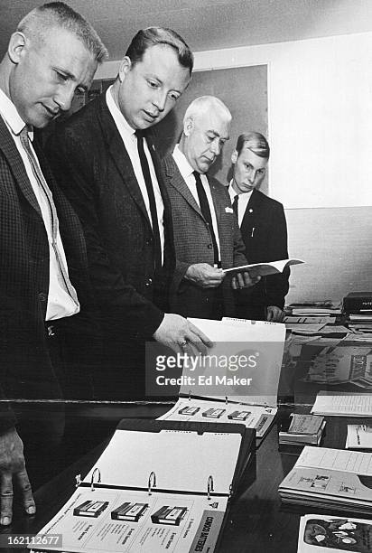 Four loaned executives look over publications at the Boy's Club. They are, from left, Steve J. Farnham, Travis Townsend, E.E. Van Stee of Dow...