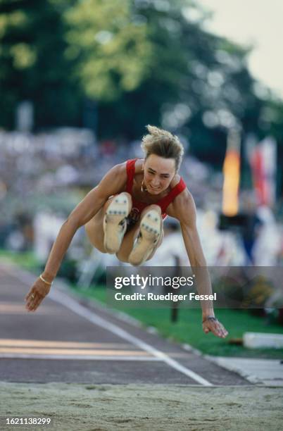 German athlete Heike Drechsler competes in the women's long jump event of the 1994 German Athletics Championships, held at the Steigerwaldstadion in...