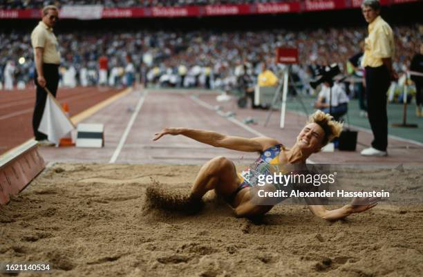 German athlete Heike Drechsler lands in the sand during the women's long jump event of the ASV-Sportfest in Cologne, North Rhine-Westphalia, Germany,...