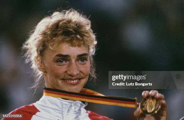 German athlete Heike Drechsler holding the gold medal she won in the women's long jump event at the 1993 IAAF World Championships, held at the...