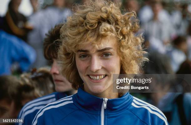 German track and field athlete Heike Drechsler, wearing the blue-and-white tracksuit of East Germany, at an athletics meeting, July 1988.