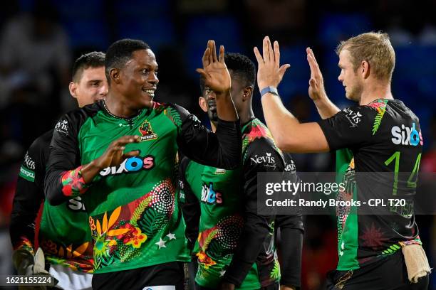Sheldon Cottrell and Corbin Bosch of Saint Kitts and Nevis Patriots celebrate the dismissal of Chanderpaul Hemraj of Guyana Amazon Warriors during...