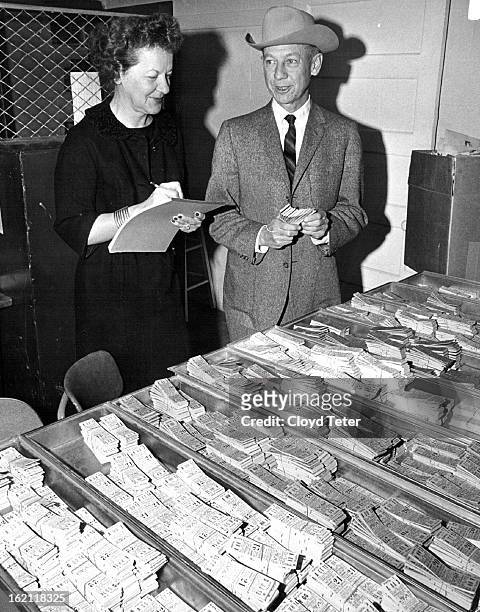 It's That Time Again; Mrs. Del Patton, 3604 Forest St., and Willard Simms, general manager of 1966 National Western Stock Show, look over some of the...