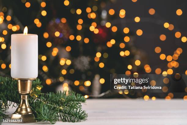 christmas decorations with white candle on table - christmas candles stockfoto's en -beelden