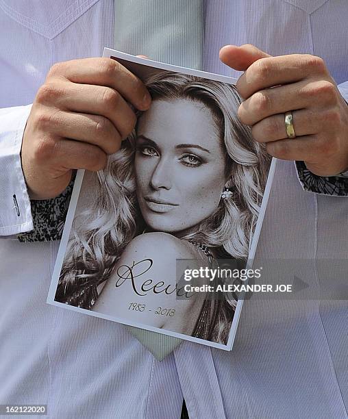 Relative of the late South African model Reeva Steenkamp holds the funeral ceremony program at the crematorium building in Port Elizabeth on February...