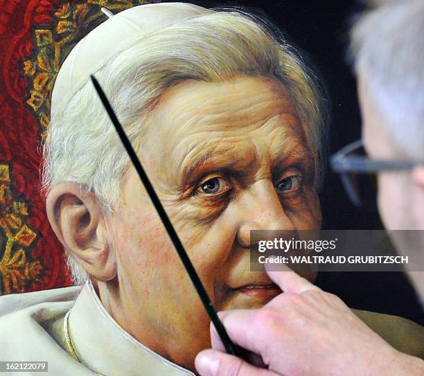 Artist Michael Triegel works on his second portrait painting of outgoing Pope Benedict XVI in his workshop in Leipzig, eastern Germany on February...