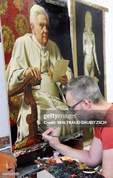 Artist Michael Triegel works on his second portrait painting of outgoing Pope Benedict XVI in his workshop in Leipzig, eastern Germany on February...