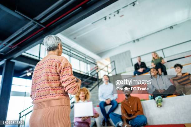 senior businesswoman doing a presentation on a office or modern university - brazil training and press conference stock pictures, royalty-free photos & images