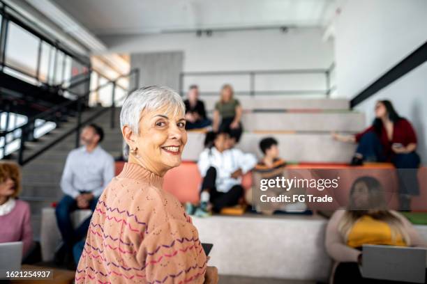 portrait of a senior businesswoman during presentation at auditorium - university professor stock pictures, royalty-free photos & images