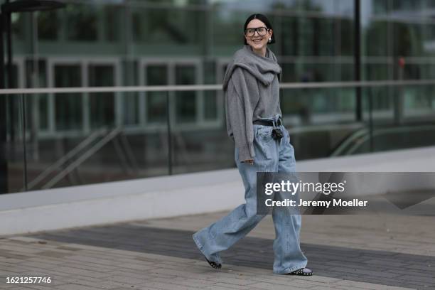 Maria Barteczko seen wearing Victoria Beckham black oversized aviator glasses, ASOS silver drop earrings, VIVAL.STUDIO grey two in one double knit...