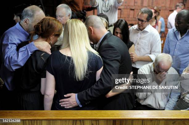 The father of South African Olympic sprinter Oscar Pistorius, Henke , reacts as relatives comfort each other on February 19, 2013 after his bail...