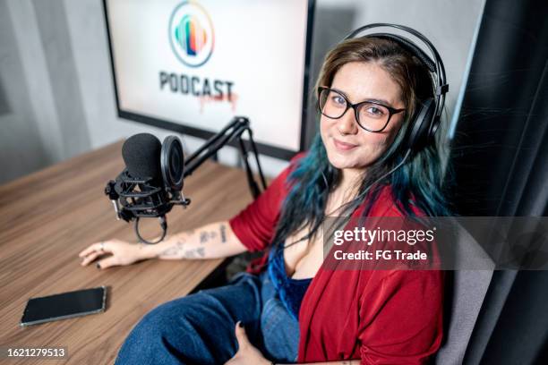 portrait of a young woman during a podcast - radio studio stock pictures, royalty-free photos & images