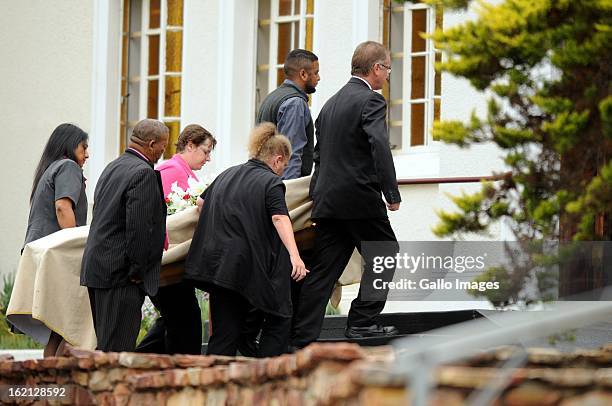 Pallbearers carry in the coffin of the late Reeva Steenkamp on February 19, 2013 in Port Elizabeth, South Africa. Steenkamp was allegedly murdered by...