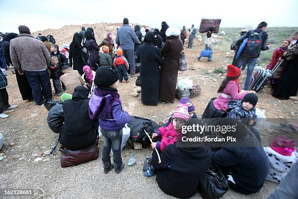 Refugees fleeing the conflict in Syria arrive to the Jordanian border at a safe crossing point commanded by the Jordanian military on February 18,...