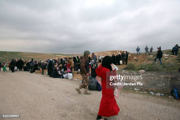 Refugees fleeing the conflict in Syria arrive to the Jordanian border at a safe crossing point commanded by the Jordanian military on February 18,...