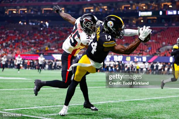 George Pickens of the Pittsburgh Steelers leaps for a reception over Natrone Brooks of the Atlanta Falcons during the first quarter of a preseason...