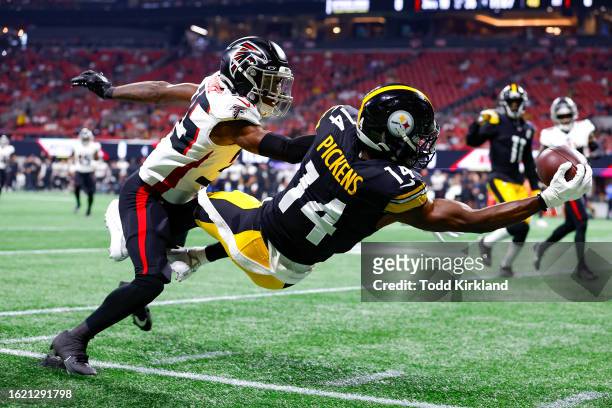 George Pickens of the Pittsburgh Steelers leaps for a reception over Natrone Brooks of the Atlanta Falcons during the first quarter of a preseason...