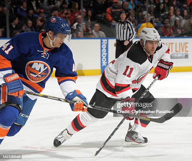 Stephen Gionta of the New Jersey Devils faces off against David Ullstrom of the New York Islanders during the game on February 16, 2013 at Nassau...