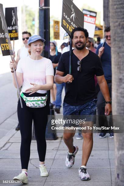 Molly Quinn and Jon Huertas walk the picket line in support of the SAG-AFTRA and WGA strike on August 24, 2023 at Warner Brothers Studios in Burbank,...