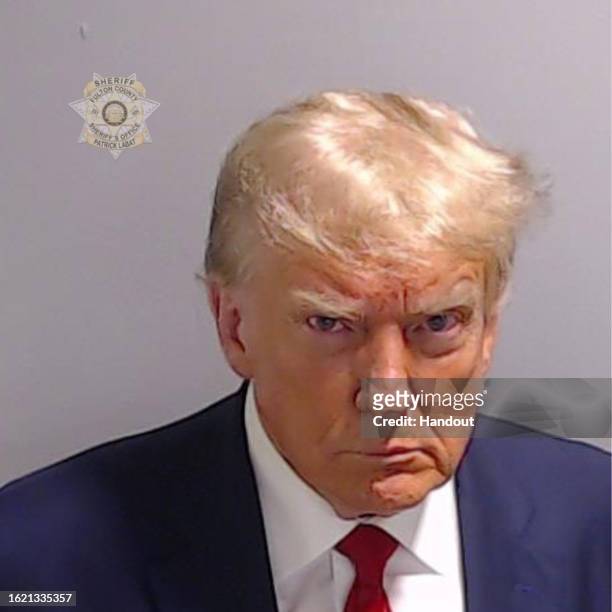 In this handout provided by the Fulton County Sheriff's Office, former U.S. President Donald Trump poses for his booking photo at the Fulton County...