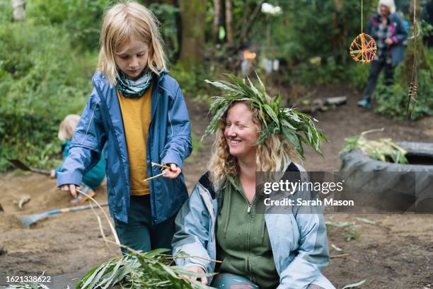 boy picks leaves to make leaf crown - british crown stock pictures, royalty-free photos & images