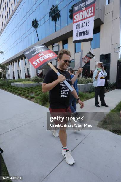 Adam Conover walks the picket line in support of the SAG-AFTRA and WGA strike outside of Sunset Bronson Studios on August 24, 2023 in Hollywood,...