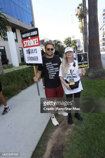 Adam Conover and Frances Fisher walk the picket line in support of the SAG-AFTRA and WGA strike outside of Sunset Bronson Studios on August 24, 2023...