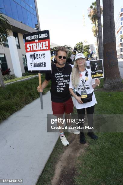 Adam Conover and Frances Fisher walk the picket line in support of the SAG-AFTRA and WGA strike outside of Sunset Bronson Studios on August 24, 2023...