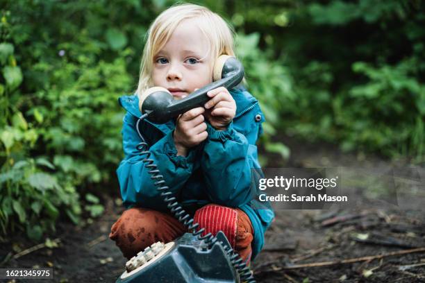 boy at forest school on pretend phone - phone receiver stock pictures, royalty-free photos & images