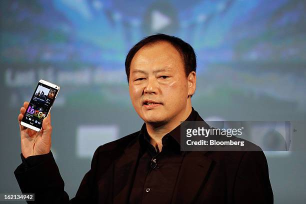 Peter Chou, chief executive officer of HTC Corp., holds a new HTC One smartphone during a launch event in London, U.K., on Tuesday, Feb. 19, 2013....