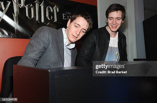 Actor Oliver Phelps and James Phelps visit The Harry Potter: The Exhibition at Discovery Times Square on February 19, 2013 in New York City.