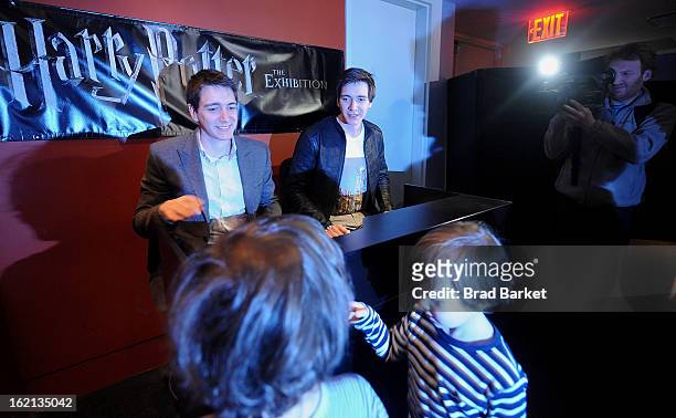 Actor Oliver Phelps and James Phelps visit The Harry Potter: The Exhibition at Discovery Times Square on February 19, 2013 in New York City.