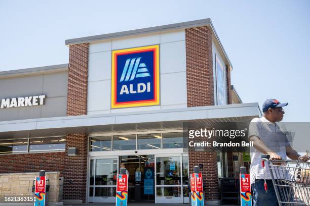 Customer walks out of an Aldi supermarket on August 17, 2023 in Pflugerville, Texas. The German Supermarket is acquiring Winn-Dixie, Harveys...