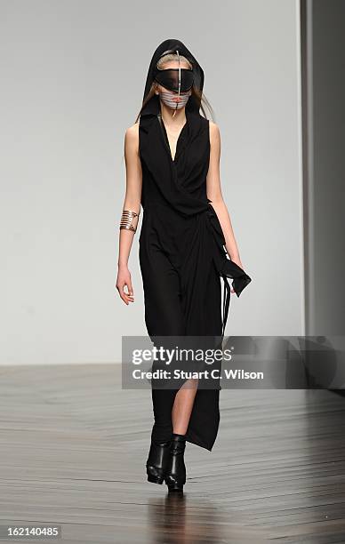 Model walks the runway at the Haizhen Wang show during London Fashion Week Fall/Winter 2013/14 at Somerset House on February 19, 2013 in London,...