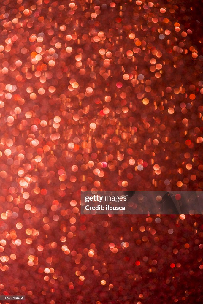 Abstract glittering paper christmas light red defocussed background