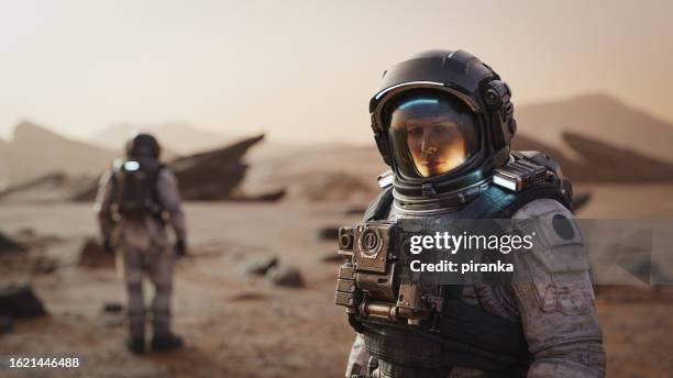 astronauts on another world - space helmet stock pictures, royalty-free photos & images