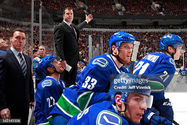 Head coach Alain Vigneault of the Vancouver Canucks looks on from the bench during their NHL game against the Dallas Stars at Rogers Arena February...