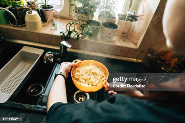 preparing food at home in the kitchen. cooking food - passoire photos et images de collection