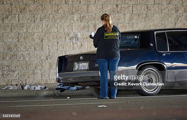 Orange County Sheriff deputies investigate a crime scenes on February 19, 2013 in Tustin, California. According to law enforcement officials six...