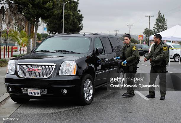 Orange County Sheriff deputies investigate a crime scene on February 19, 2013 in Tustin, California. According to law enforcement officials six...