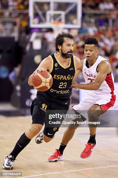 Sergio Llul of the Spain Men's National Basketball Team competes for the ball with Trae Bell-Haynesfeb of the Canada Men's National Basketball Team...