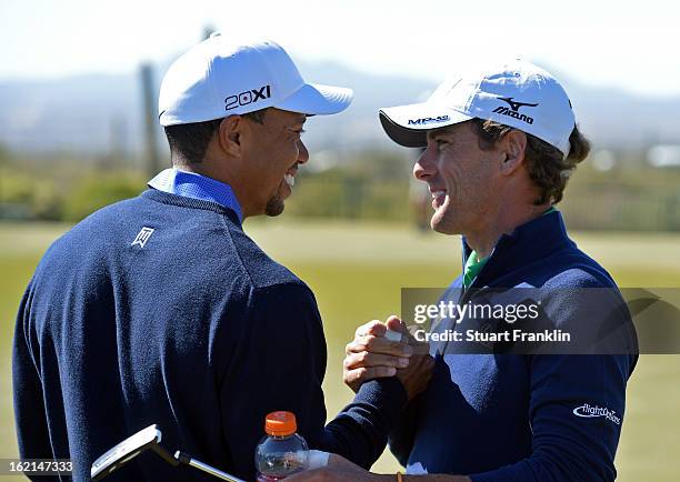 Tiger Woods of USA greets his apponant of the first day Charles Howell III of USA during practice prior to the start of the World Golf...